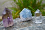 Tri Colored Healing Crystals Placed On A Rock For Healing Purpose.