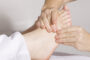 A Woman Experiencing Feet Massage Therapy.