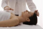 A Reiki Specialist Treating His Patient.