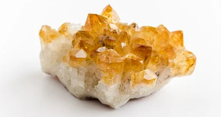 Orange Quartz Uncut Crystal Placed On A White Table.