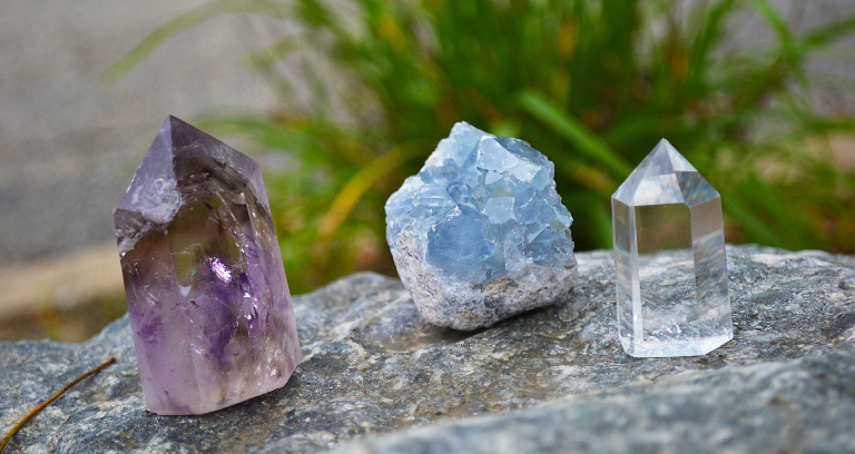 Tri Colored Healing Crystals Placed On A Rock For Healing Purpose.