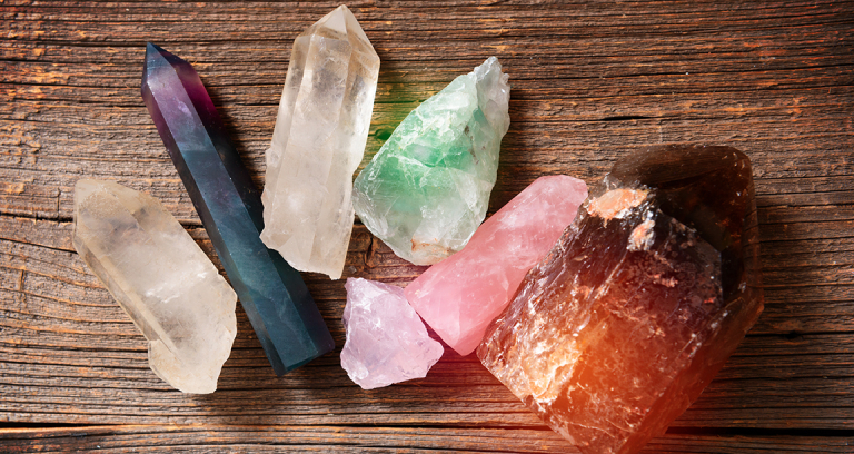 Natural Gemstones Of Multiple Colors On A Wooden Board.