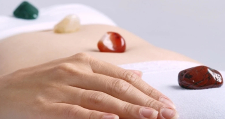 A Woman In A Therapy Room For Crystal Massage.