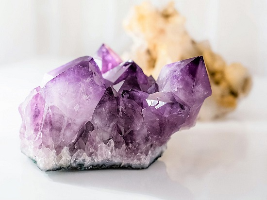 A Voilet Colored Rock Crystal Placed On the Table.