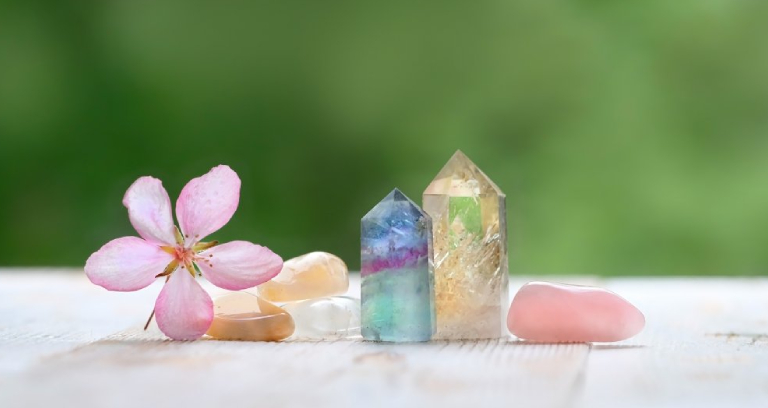 Mutile Precious Gemstone Crystals With A Flower Placed On The Table