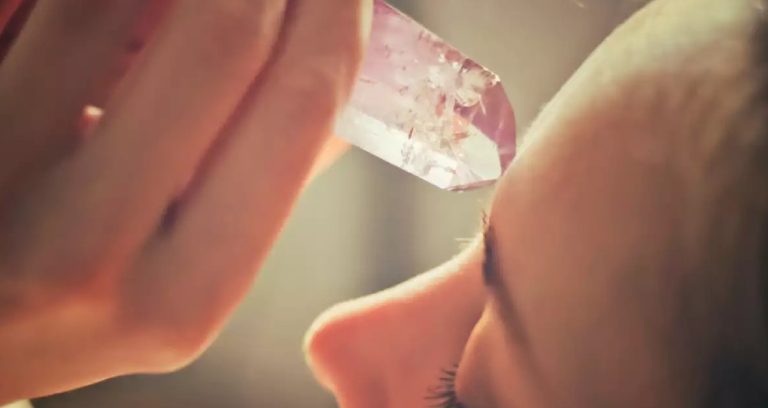 A Woman On A Therapy Room For Crystal Massage For Her head.