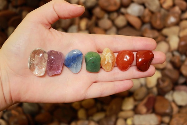 A Young Girl Keeps Rainbow Colored Gemstones.