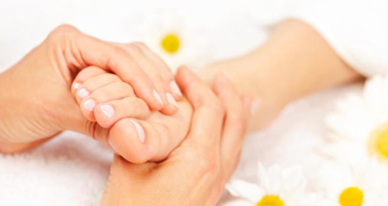 Young Woman Having Feet Massage Therapy.