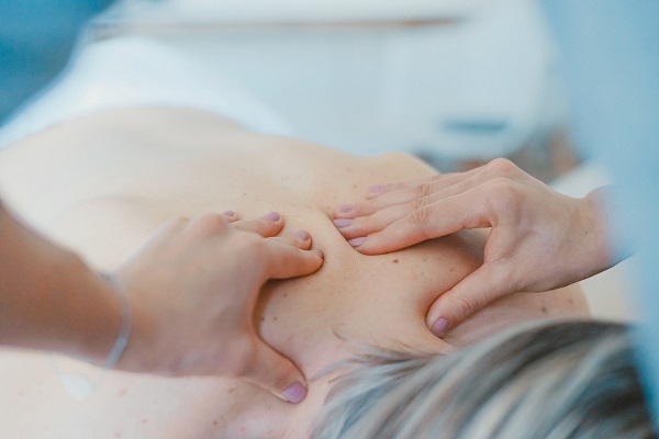 An Old Lady Relaxing With Back Massage In A Therapy Room.