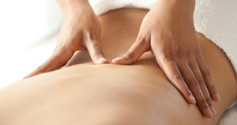 A Therapist Giving Back Massage To A Male Patient.