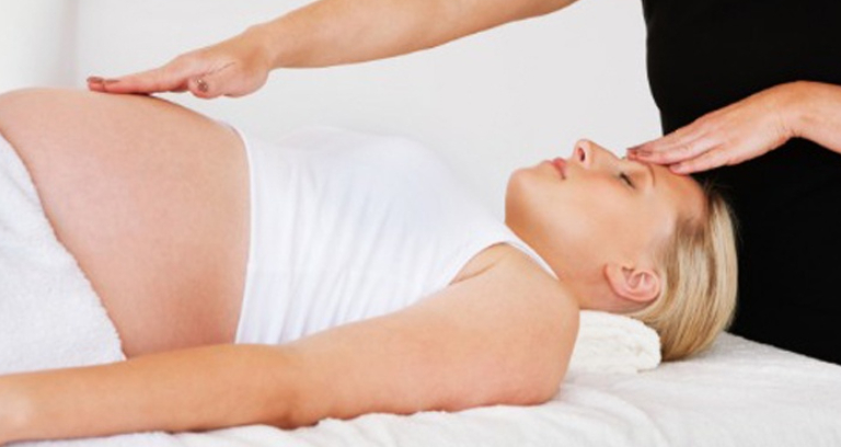 A pregnant Woman Getting Massage During Her Pregnancy Period.
