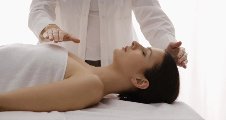 A Reiki Specialist Treating His Patient.