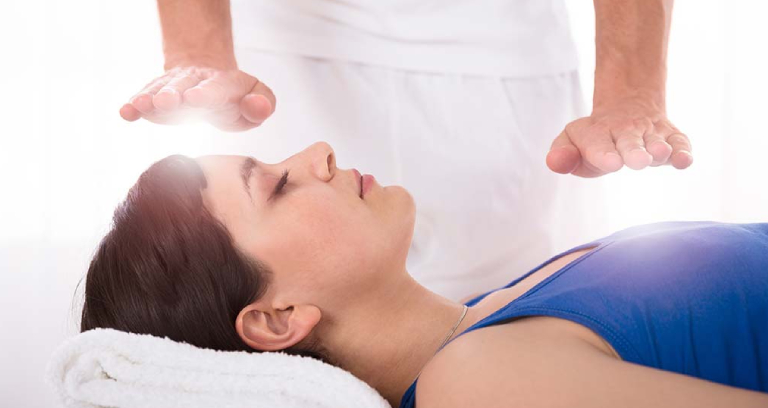 A Young Woman Getting Reiki Massage.