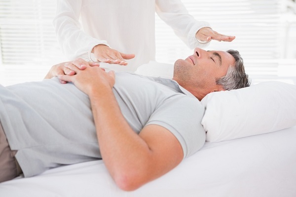 An Old Man Relaxing While Reiki Healing.