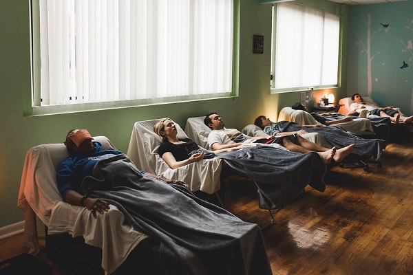 Patients Lying In A Comfortable Bed During Their Acupunture Process.