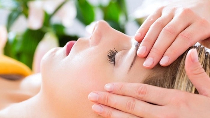 A Closup Look of Woman Getting Reiki Massage For Head.