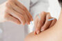 A Therapist Giving Dry Needling Treatment For A Woman In A Therapy Room.