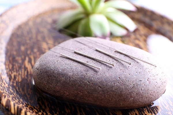 Acupunture Needles Placed On A Rock For Medical Purpose.