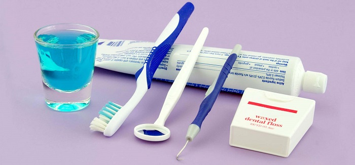 Image represents teeth and gums cleaning tools such as mouth wash, brush, toothpaste and floss