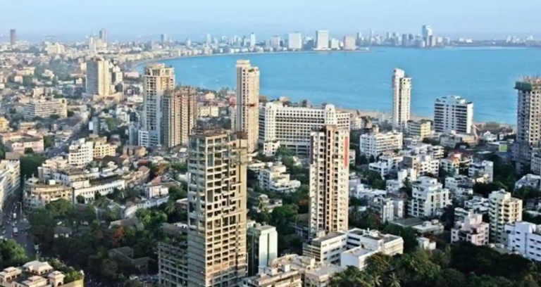 Rows of high rise buildings by the side of the sea.