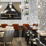 Indoor setup of a restaurant with white light settings and decorative dining table sets.