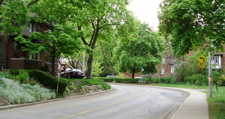 Rows of houses with trees in a neighborhood.