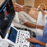 A doctor is taking abdomen scan of the patient
